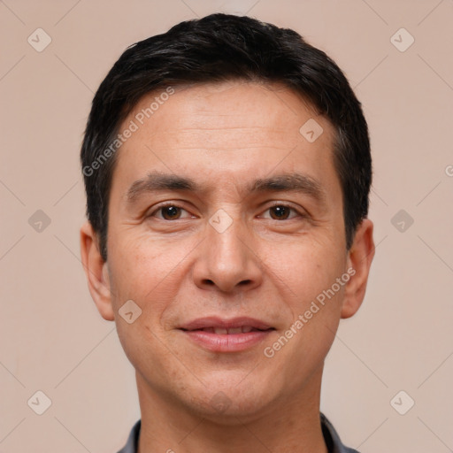 Joyful white adult male with short  black hair and brown eyes