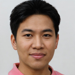 Joyful asian young-adult male with short  brown hair and brown eyes