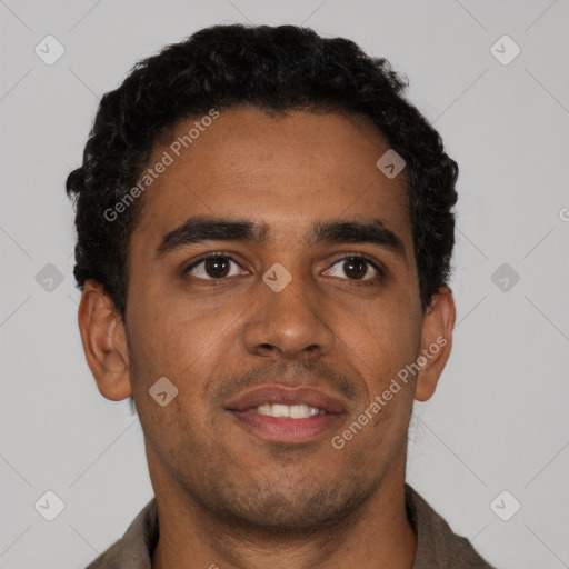 Joyful black young-adult male with short  brown hair and brown eyes