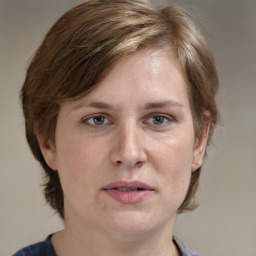 Joyful white adult female with medium  brown hair and grey eyes