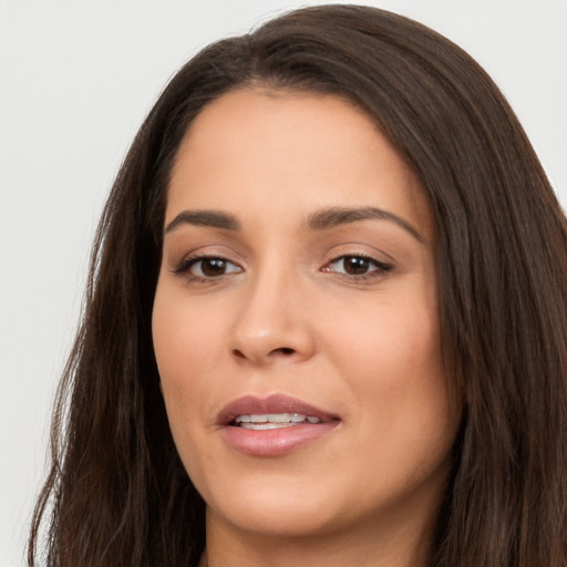 Joyful white young-adult female with long  brown hair and brown eyes