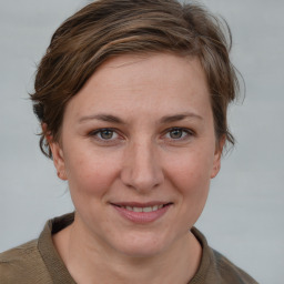 Joyful white young-adult female with medium  brown hair and blue eyes