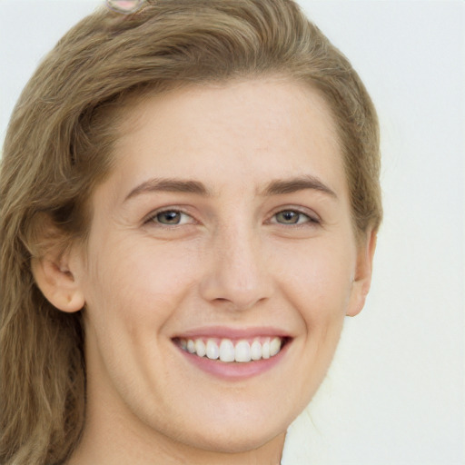 Joyful white young-adult female with long  brown hair and green eyes