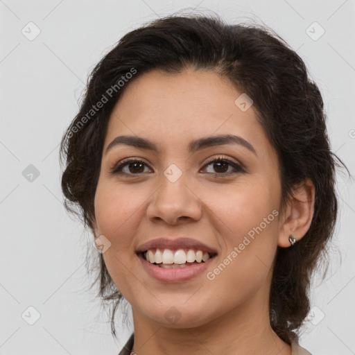 Joyful latino young-adult female with medium  brown hair and brown eyes