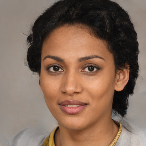 Joyful black young-adult female with medium  brown hair and brown eyes