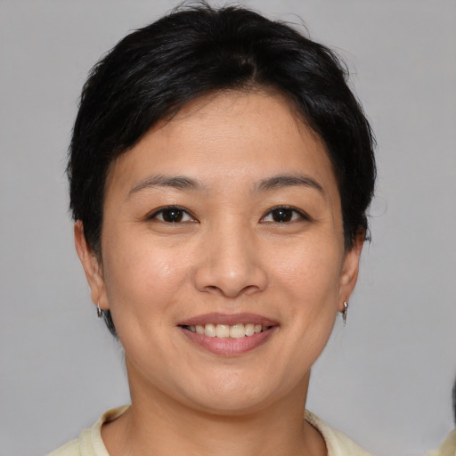 Joyful asian young-adult female with short  brown hair and brown eyes
