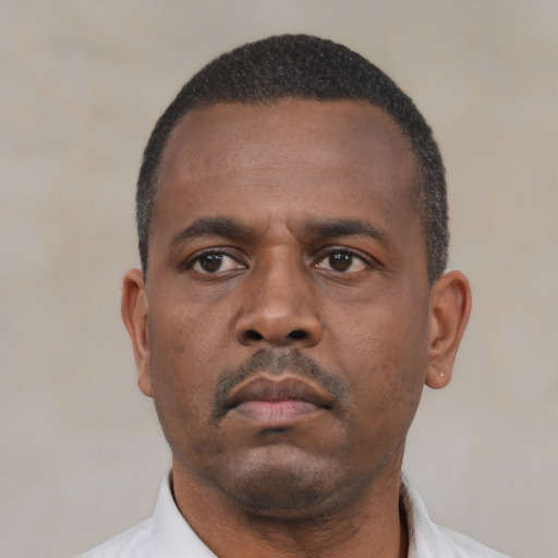 Neutral black adult male with short  black hair and brown eyes
