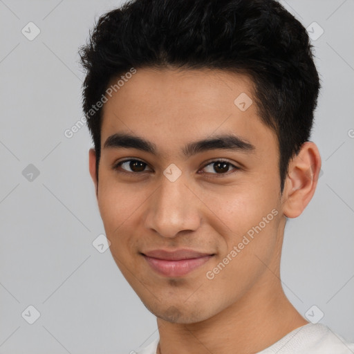 Joyful latino young-adult male with short  black hair and brown eyes