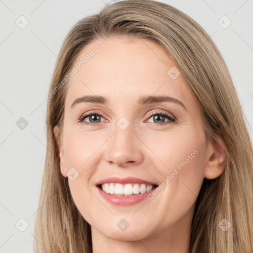 Joyful white young-adult female with long  brown hair and grey eyes