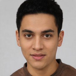 Joyful latino young-adult male with short  brown hair and brown eyes