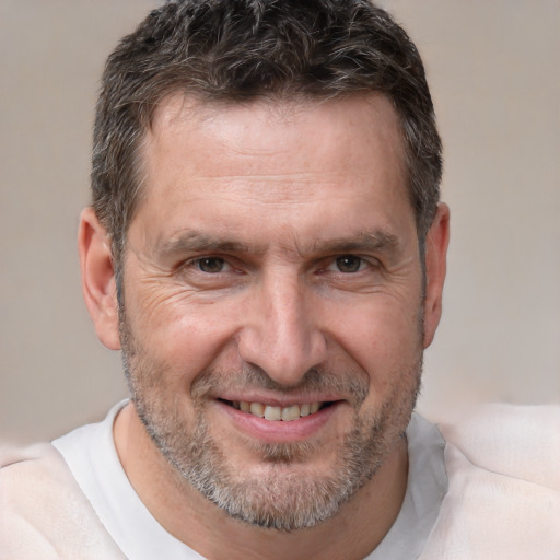 Joyful white adult male with short  brown hair and brown eyes