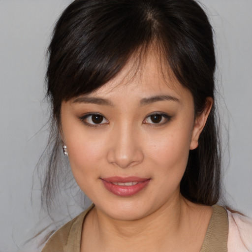 Joyful asian young-adult female with medium  brown hair and brown eyes