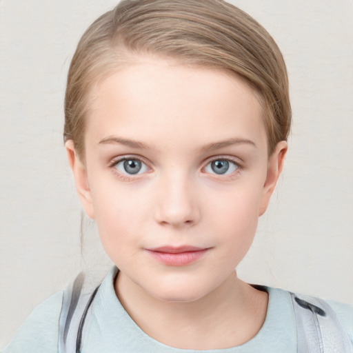 Joyful white child female with short  brown hair and blue eyes