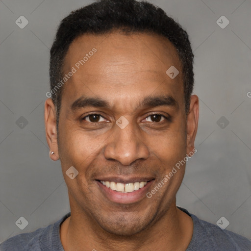 Joyful latino adult male with short  black hair and brown eyes