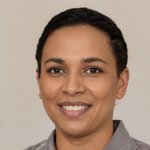 Joyful latino adult female with short  black hair and brown eyes