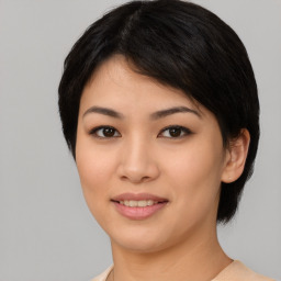 Joyful asian young-adult female with medium  black hair and brown eyes