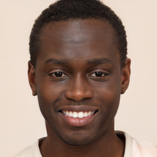 Joyful black young-adult male with short  brown hair and brown eyes