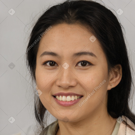 Joyful latino young-adult female with medium  brown hair and brown eyes