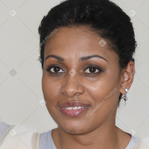 Joyful black young-adult female with short  brown hair and brown eyes