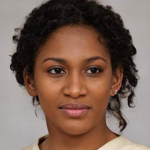 Joyful black young-adult female with medium  brown hair and brown eyes