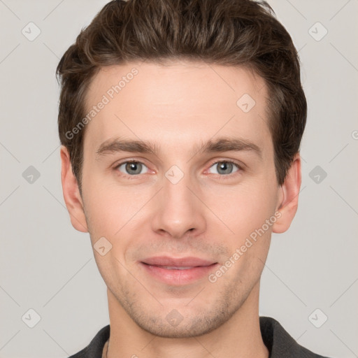 Joyful white young-adult male with short  brown hair and grey eyes