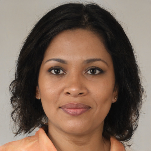 Joyful black adult female with medium  brown hair and brown eyes