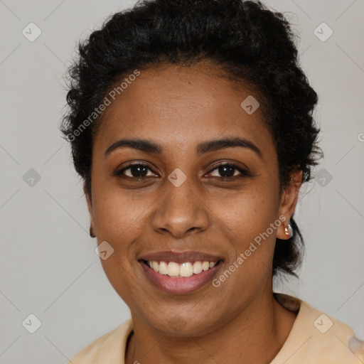 Joyful black young-adult female with short  black hair and brown eyes