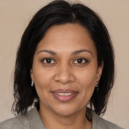 Joyful black adult female with medium  brown hair and brown eyes