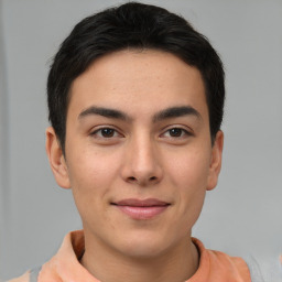 Joyful latino young-adult male with short  brown hair and brown eyes