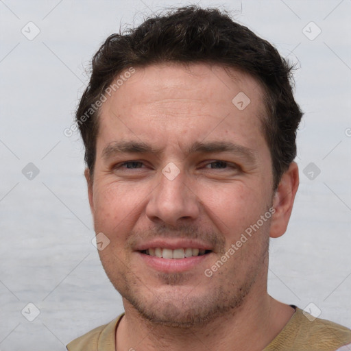 Joyful white adult male with short  brown hair and brown eyes