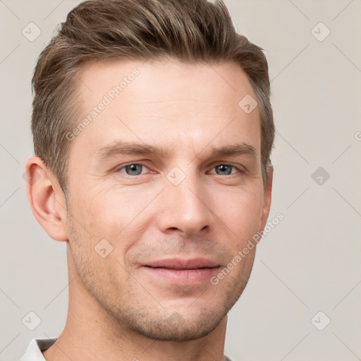 Joyful white young-adult male with short  brown hair and grey eyes