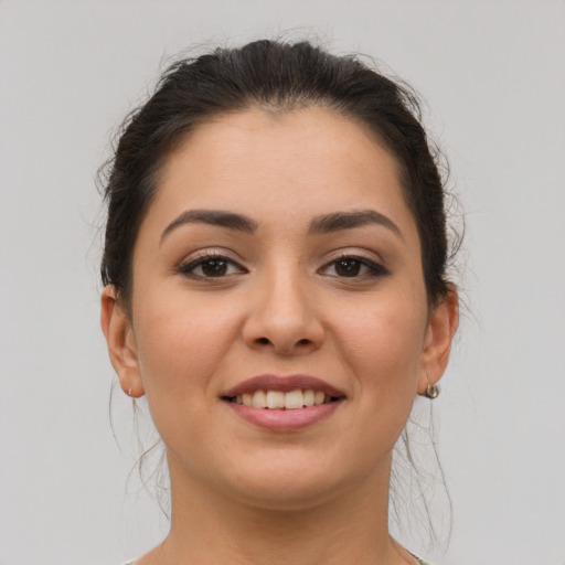 Joyful latino young-adult female with medium  brown hair and brown eyes