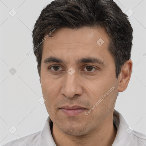 Joyful white adult male with short  brown hair and brown eyes