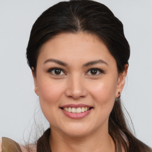 Joyful white young-adult female with long  brown hair and brown eyes