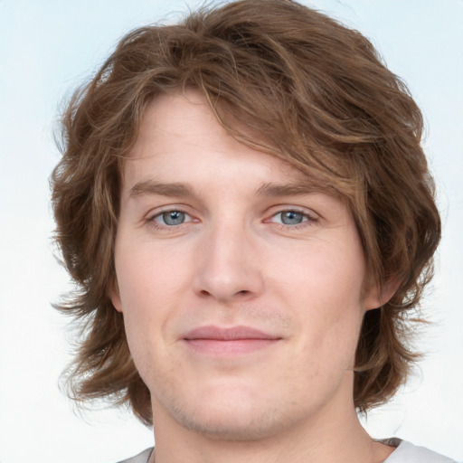 Joyful white young-adult male with medium  brown hair and blue eyes