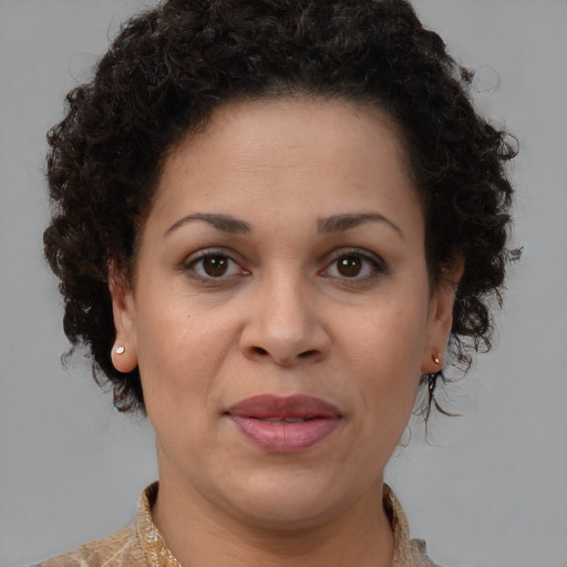 Joyful black adult female with medium  brown hair and brown eyes