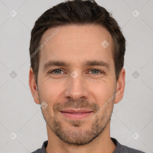 Joyful white adult male with short  brown hair and brown eyes