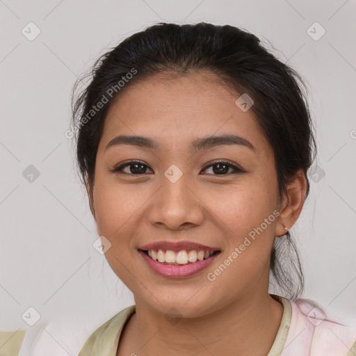 Joyful latino young-adult female with medium  brown hair and brown eyes