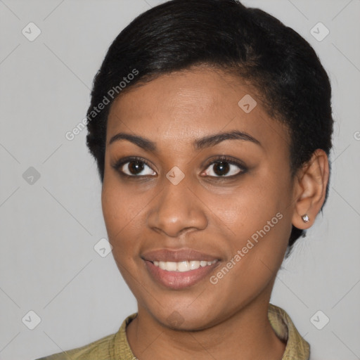 Joyful black young-adult female with short  brown hair and brown eyes