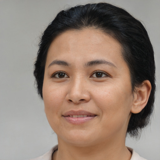 Joyful asian young-adult female with medium  brown hair and brown eyes