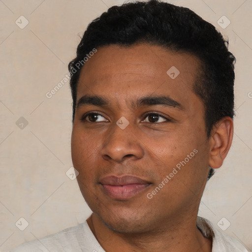 Joyful black young-adult male with short  black hair and brown eyes