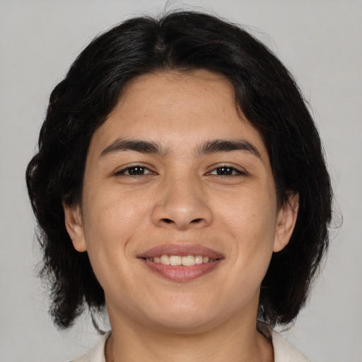 Joyful asian adult male with medium  brown hair and brown eyes