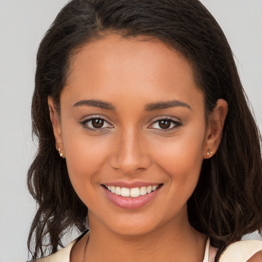 Joyful white young-adult female with long  brown hair and brown eyes