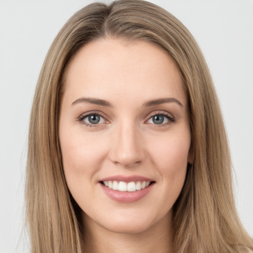 Joyful white young-adult female with long  brown hair and green eyes