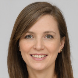 Joyful white young-adult female with long  brown hair and grey eyes