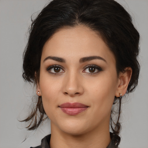 Joyful latino young-adult female with medium  brown hair and brown eyes