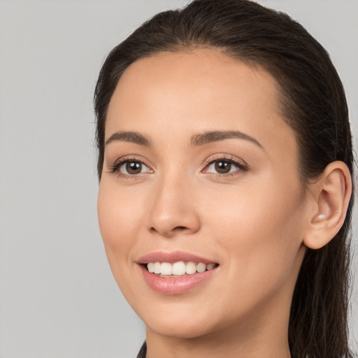 Joyful white young-adult female with long  brown hair and brown eyes