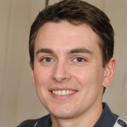 Joyful white young-adult male with short  brown hair and brown eyes