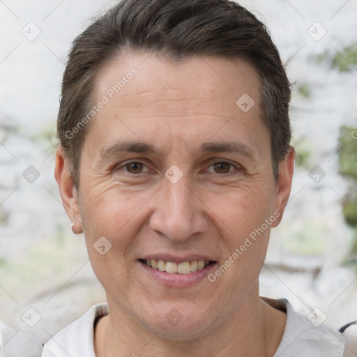 Joyful white adult male with short  brown hair and brown eyes