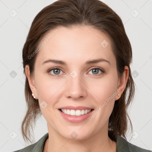 Joyful white young-adult female with medium  brown hair and grey eyes